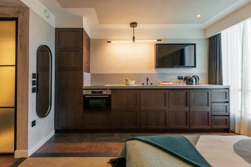 a kitchen with a sink and a tv on the wall at Staycity Aparthotels London Dalston in London