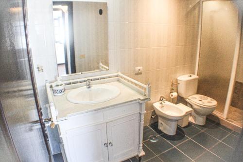 a bathroom with a sink and a toilet at Habitaciones Doña Cris in Puerto del Carmen