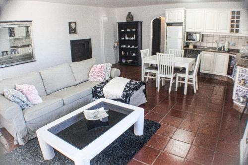 a living room with a couch and a table at Habitaciones Doña Cris in Puerto del Carmen