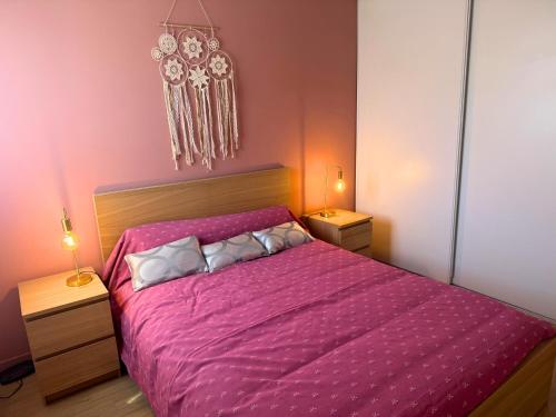 a bedroom with a pink bed with two night stands at Vintage - Calme - Elégant - Terrasse in Saint-Paul-lès-Dax