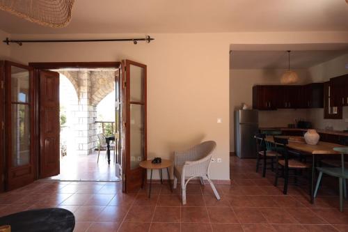 a kitchen and dining room with a table and chairs at CASA DI MANI KOTRONI Vacation 2 bedroom Maisonette with shared pool in Kotrónion