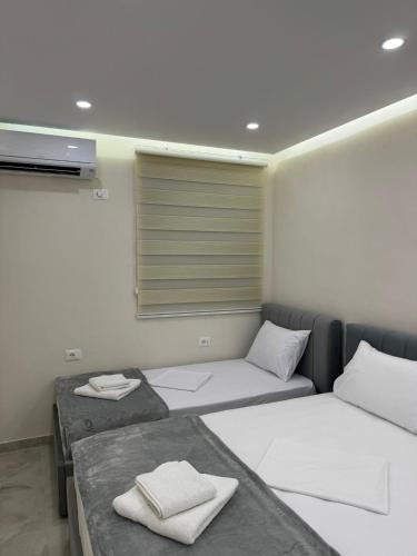 a room with two beds and a window at A3 Apartments in Velipojë