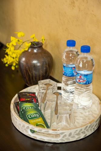 a tray with drinks and bottles of water on a table at Amazing Ninh Binh Garden in Xuân Sơn
