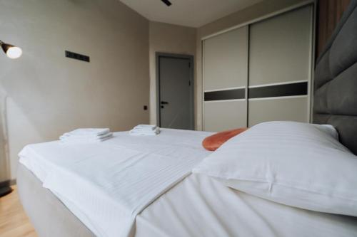 a bedroom with a large white bed with white sheets at Quiet 1BR Retreat 2min to Transit and Shops in Chişinău