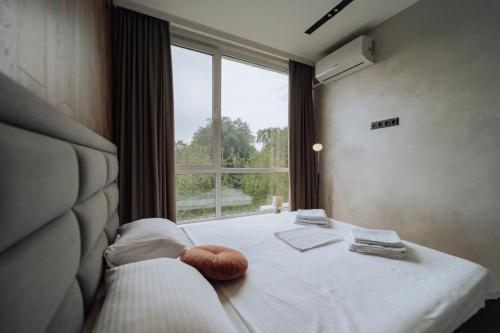 a bedroom with a bed with a large window at Quiet 1BR Retreat 2min to Transit and Shops in Chişinău