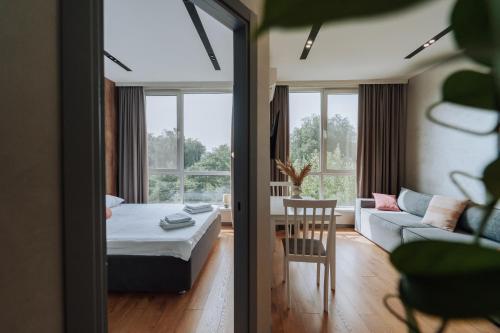 a room with a bed and a couch and a table at Quiet 1BR Retreat 2min to Transit and Shops in Chişinău