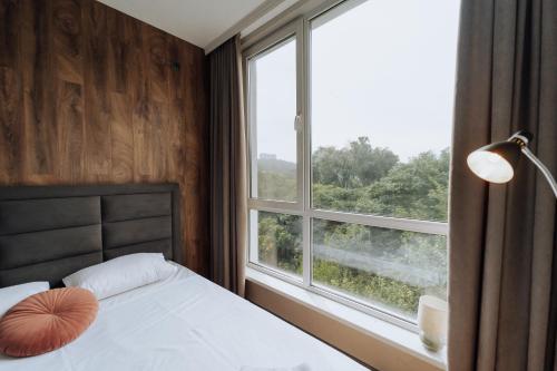 a bedroom with a bed and a large window at Quiet 1BR Retreat 2min to Transit and Shops in Chişinău