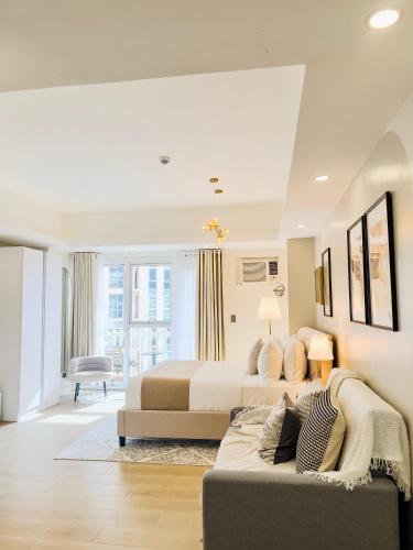 a large bedroom with two beds and a couch at Casa Elisae l Venice Grand Canal Mall Access in Manila