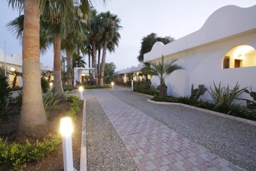 a pathway with lights in front of a house at Garden Hotel Ripa in Vieste