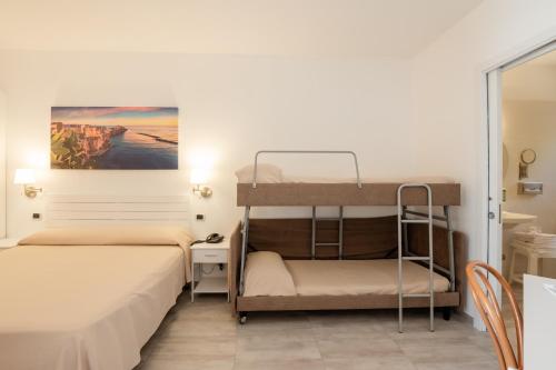 a room with two bunk beds and a desk at Garden Hotel Ripa in Vieste