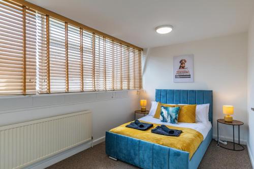 a bedroom with a blue bed and a window at Spacious Winchester Duplex in Winchester