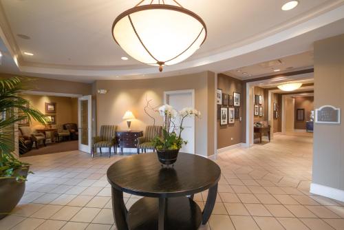 a lobby with a table with flowers on it at The Glen Club in Glenview
