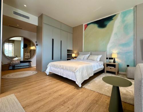 a bedroom with a bed and a large painting on the wall at Boka Place Home Thea in Tivat