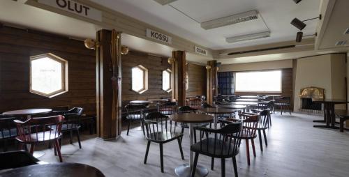 a row of tables and chairs in a restaurant at Lapland Hotels Kilpis in Kilpisjärvi