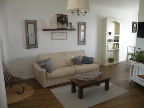 a living room with a couch and a coffee table at Il Nido nel Borgo in Valfabbrica