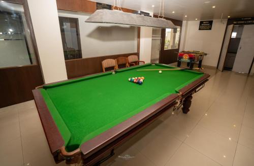 a pool table with balls on top of it at Hotel Vrishali Executive in Kolhapur