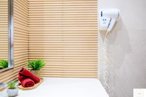 a phone hanging on a wall in a bathroom at YamaLuxe Luxury Apartments - București in Bucharest