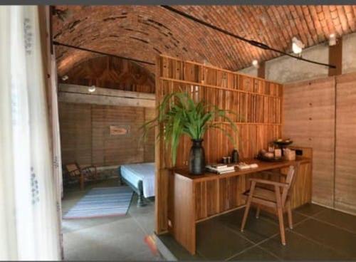 a room with a desk and a table with a plant at Tipai Wildlife Luxuries in Pahāpal