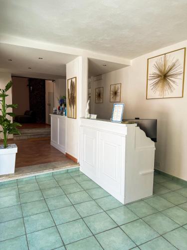a lobby with a counter and a tile floor at Hotel Residence Eden in Palinuro