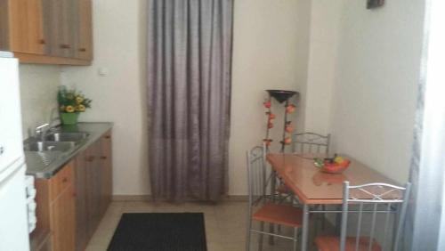 a kitchen with a table and a table and a dining room at Rethymno Rustic Serenity in Rethymno Town