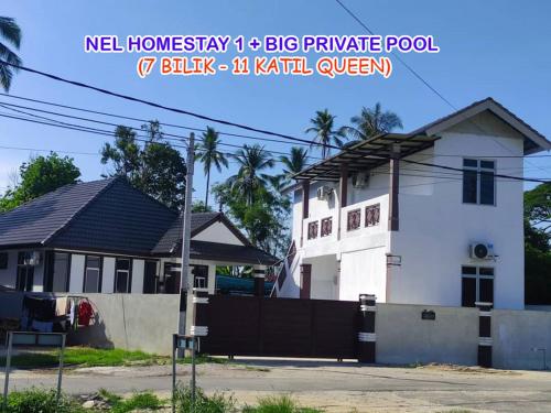 a white house with a black fence in front of it at Nel Homestay 1 with BIG Private Pool at Kota Bharu in Kota Bharu