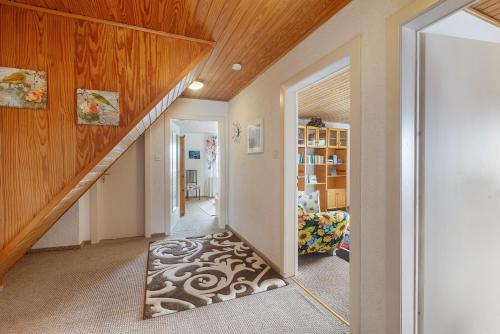a mirror in the hallway of a home with a staircase at Ferienwohnung Schloss-See-Bergblick in Waldeck