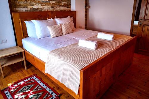 a bedroom with a large bed with two boxes on it at Porta7 Hotel in Gjirokastër