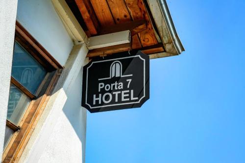 a sign for a hotel on the side of a building at Porta7 Hotel in Gjirokastër