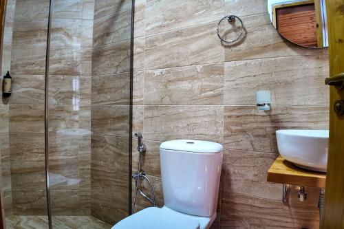 a bathroom with a toilet and a sink at Porta7 Hotel in Gjirokastër