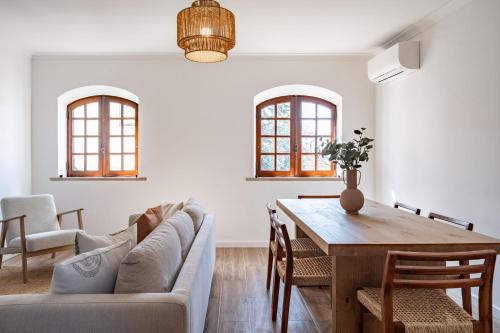a living room with a couch and a table at Sesimbra Townhouse - 3 bedroom house in Sesimbra center in Sesimbra