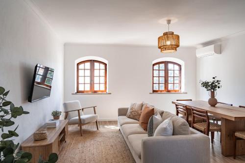 a living room with a couch and a table at Sesimbra Townhouse - 3 bedroom house in Sesimbra center in Sesimbra