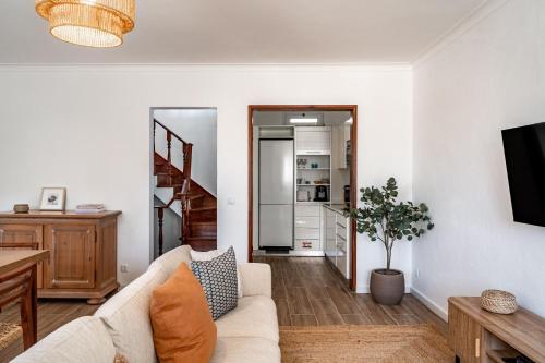 a living room with a couch and a table at Sesimbra Townhouse - 3 bedroom house in Sesimbra center in Sesimbra