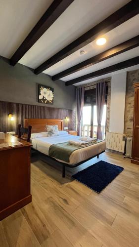 a bedroom with a large bed in a room at Rústico Prado da Viña in Finisterre