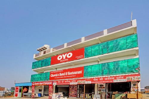 a building with red and green signs on it at Hotel O Chawla's Hotel & Restaurant in Gurgaon