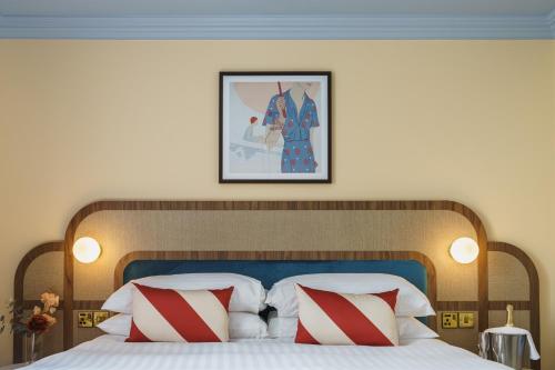 a bedroom with a large bed with red and white pillows at Grange Hotel in Grange Over Sands