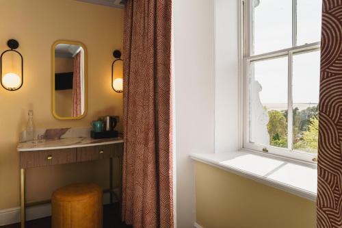 a bathroom with a sink and a window at Grange Hotel in Grange Over Sands