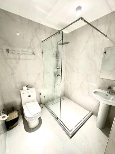 a bathroom with a shower and a toilet and a sink at North Star Hotel in Yakkasaray