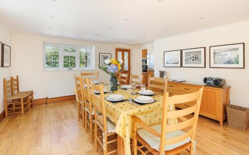 a dining room with a table and chairs at Rookley Farm Lodge Charming Manor Pool House with Heated Pool, Tennis Court & Gardens - Isle of Wight Rural Countryside Escape in Rookley