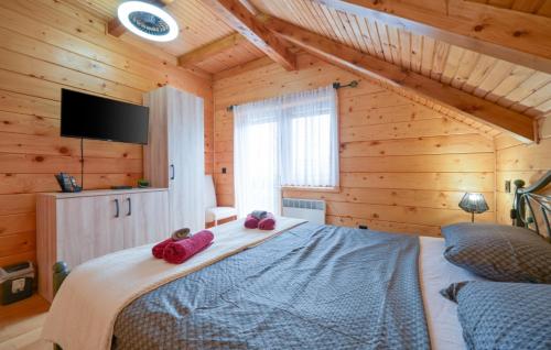a bedroom with a bed with two pink slippers at Villa Luna - Ludbreg by Villas Guide in Ludbreg