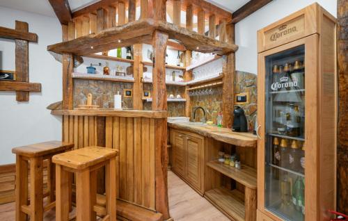 a kitchen with a bar with wooden cabinetry at Villa Luna - Ludbreg by Villas Guide in Ludbreg
