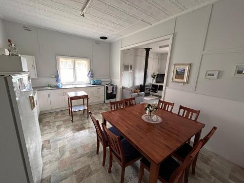 a kitchen and dining room with a table and chairs at Kandos Cottage in Kandos