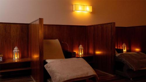 a bedroom with two beds and two lights on the wall at Mount Wolseley Hotel Spa & Golf Resort in Tullow