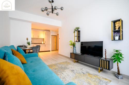 a living room with a blue couch and a flat screen tv at YamaLuxe Luxury Apartments - București in Bucharest