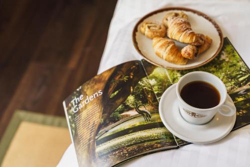 a plate of pastries and a cup of coffee on a table at Grange Hotel in Grange Over Sands
