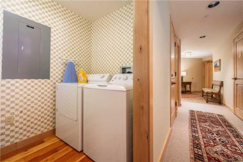 a kitchen with a white refrigerator in a room at RMR: Cody House B Condo in Teton Village in Teton Village