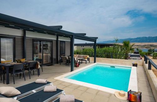 a house with a swimming pool and a patio at Terra Park SpiritoS in Kolan