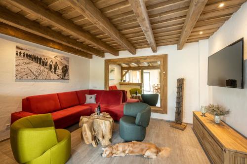 a living room with a couch and a cat laying on the floor at Almdorf Auszeit Fageralm in Forstau