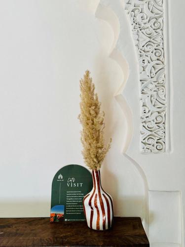a vase with a plant in it sitting on a table at Riad Dar Alif & SPA in Marrakech