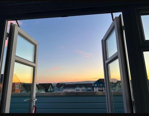 an open window with a view of a city at Madison Wharf - Waterside - Balcony in Exmouth