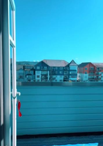 a window with a view of a city at Madison Wharf - Waterside - Balcony in Exmouth
